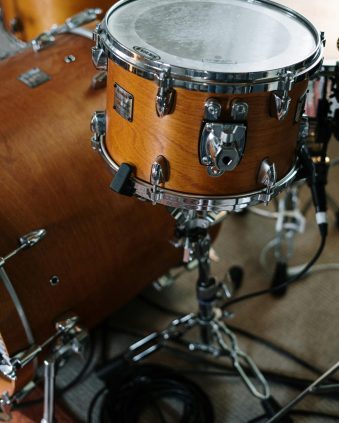 pexels photo 4087992 4087992 Close-up of a wooden drum set in a music studio, capturing musical detail.