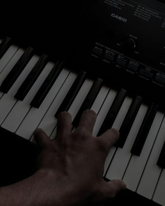pexels photo 9507849 9507849 A hand playing keys on an electronic keyboard with visible branding, captured in a close-up shot.